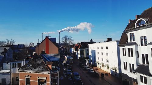 Panoramic view of city against blue sky