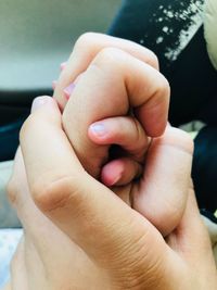 Close-up of baby holding hands