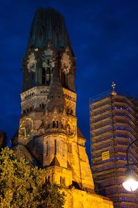 Low angle view of illuminated cathedral against sky at night