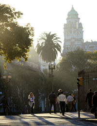 People on street amidst buildings in city