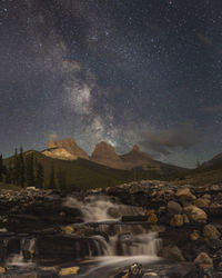 Scenic view of mountains against sky at night