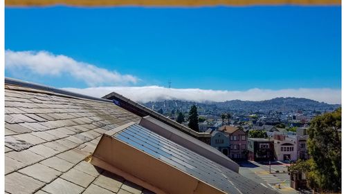 High angle view of buildings against blue sky