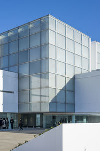 Low angle view of modern building against clear blue sky