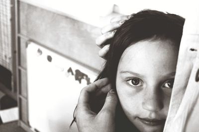 Portrait of girl standing with mother at home