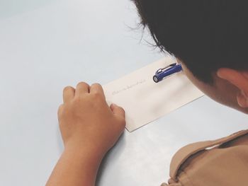 Close-up of man writing on envelope