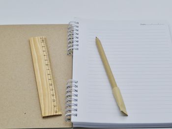 High angle view of pencil on book