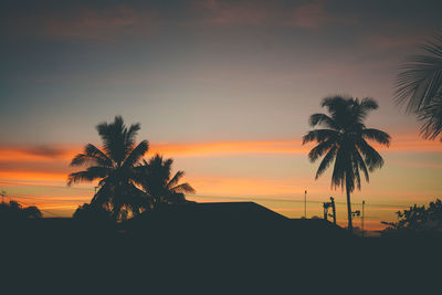 Silhouette palm trees against sky during sunset