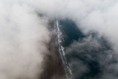 Aerial view of clouds covering sea