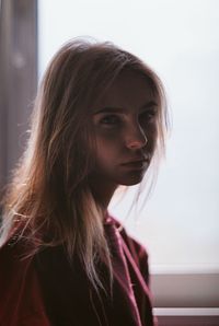 Close-up portrait of young woman at home