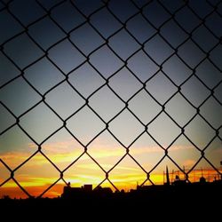 Sunset seen through chainlink fence