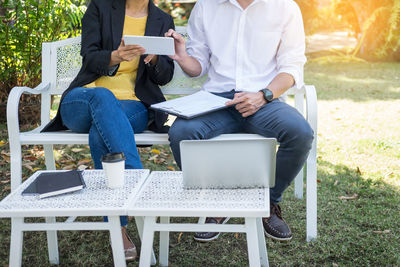 Rear view of men sitting on chair