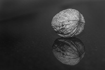 Reflection of walnut over black background