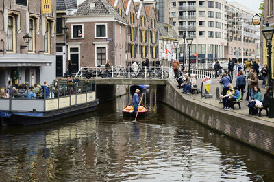 People on canal in city