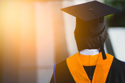 Rear view of person wearing graduation gown