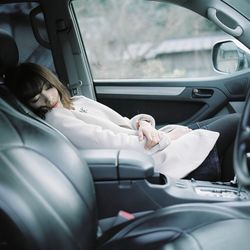 Side view of a man sitting in car