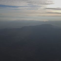 Scenic view of mountains against sky at sunset