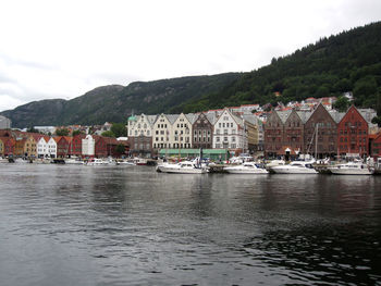 Scenic view of sea by town against sky