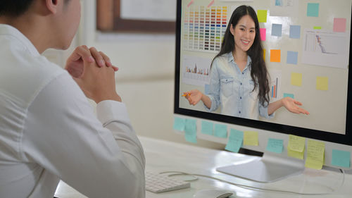 Midsection of woman using laptop on table
