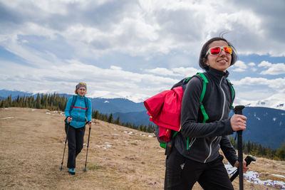 Portrait of young man standing against mountain