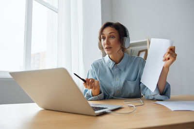 Young woman using laptop at home