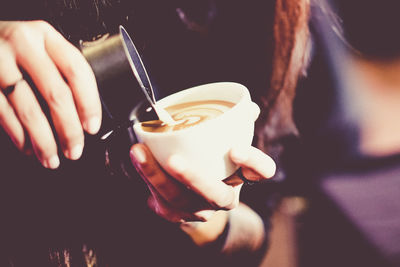 Close-up of woman holding coffee cup