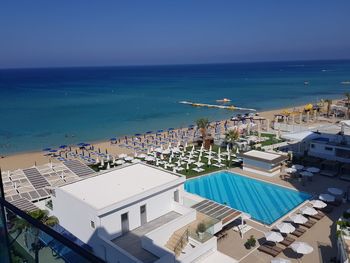 High angle view of swimming pool by sea against sky