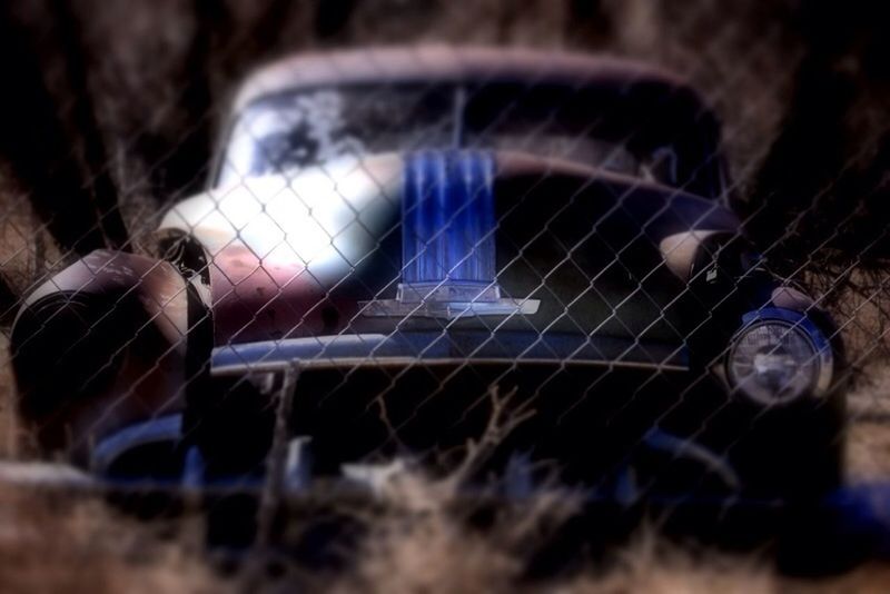 selective focus, close-up, metal, focus on foreground, reflection, no people, focus on background, indoors, protection, fence, built structure, day, broken, chainlink fence, abandoned, pattern, safety, spider web, metallic