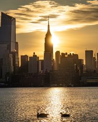 Buildings in city during sunset