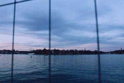 Scenic view of river against sky at dusk