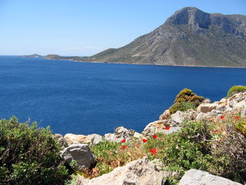 Scenic view of sea and mountains against sky