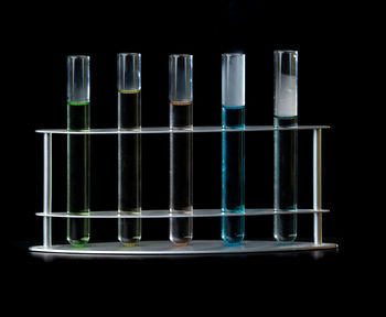 Low angle view of illuminated lights against black background