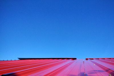 Low angle view of road against clear blue sky