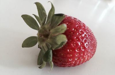 Close-up of strawberry over white background