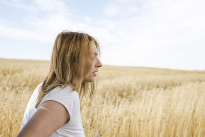 Side view of woman standing on field