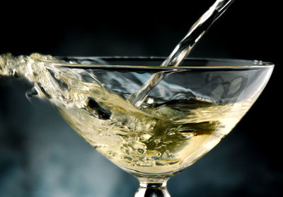 Close-up of wine glass against white background