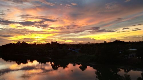 Scenic view of lake against orange sky