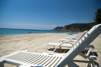 Empty beach against clear sky