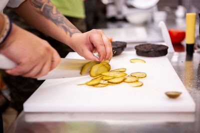 Cropped hand of person preparing food