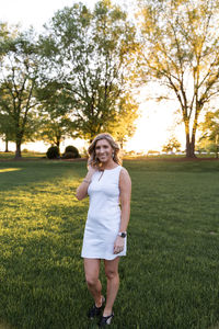 Portrait of smiling woman standing on field