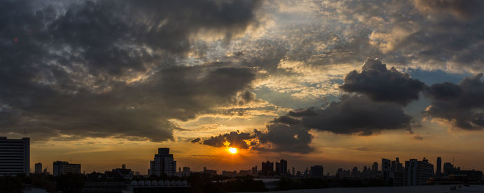 View of cityscape against cloudy sky during sunset