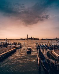 Scenic view of sea against cloudy sky during sunset