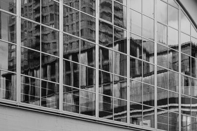 Low angle view of glass building in city