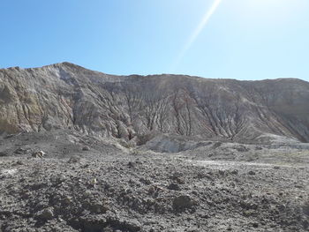 Scenic view of arid landscape against sky