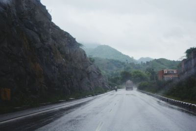 Road amidst mountains against sky