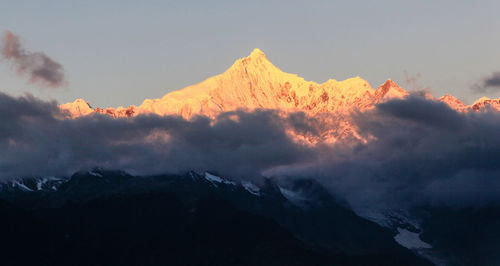 Scenic view of mountains against cloudy sky