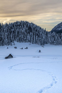Scenic view of snow covered field against sky