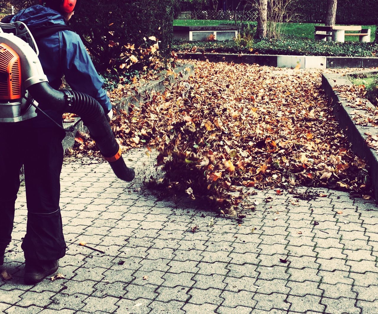 LOW SECTION OF MAN STANDING ON COBBLESTONE