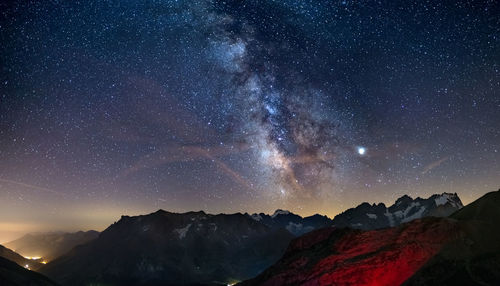 Scenic view of mountains against sky at night