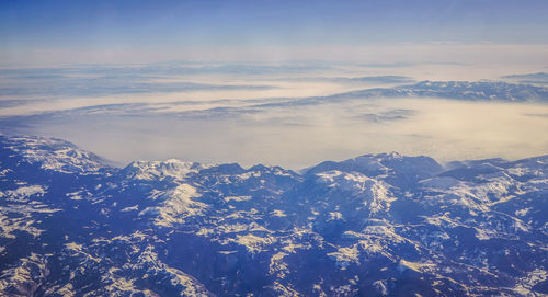 Scenic view of snowcapped mountains against sky