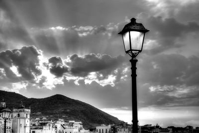 Low angle view of street light and buildings against sky